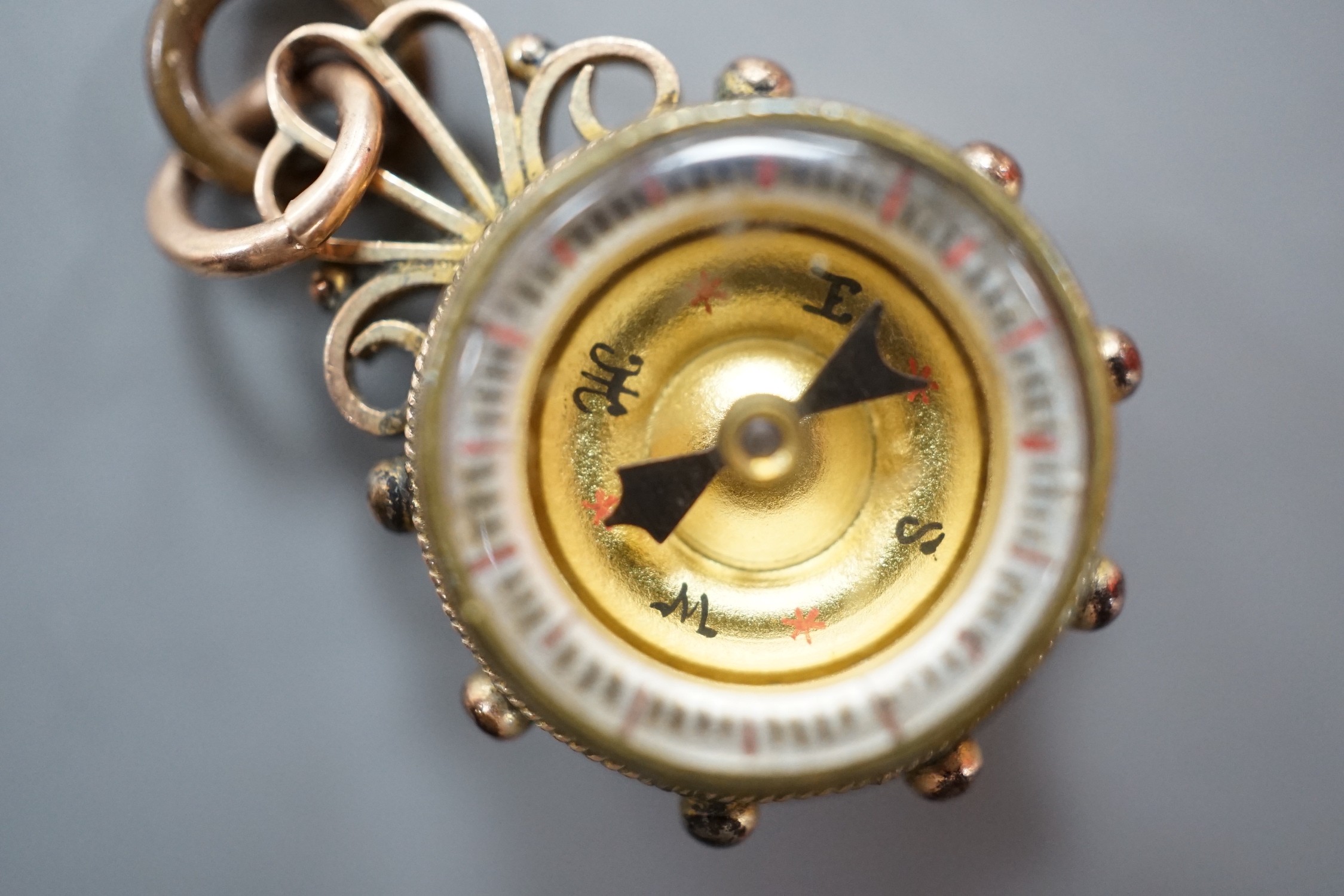 A late Victorian 9ct gold mounted Essex crystal and compass set fob, 25mm, the crystal decorated with the head of a dog.